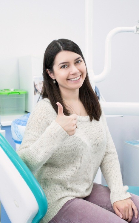 Woman giving thumbs enjoying her anxiety free dentistry visit