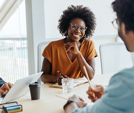 Woman smiling at colleague during work meeting