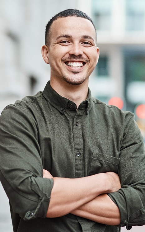 smiling man with his arms crossed