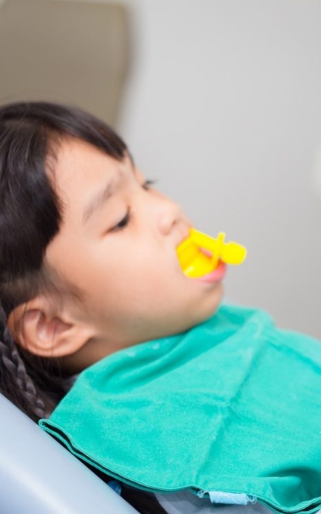 Child receiving fluoride treatment