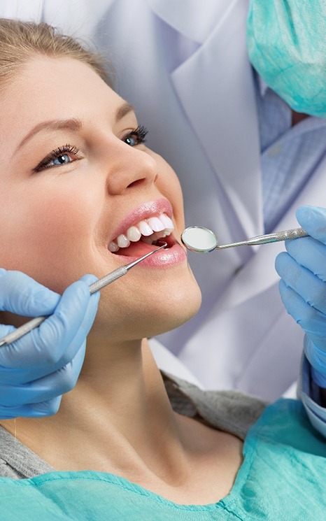 Woman with blond hair and blue eyes having dental exam