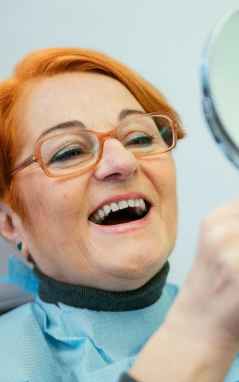 A woman enjoying her new dentures