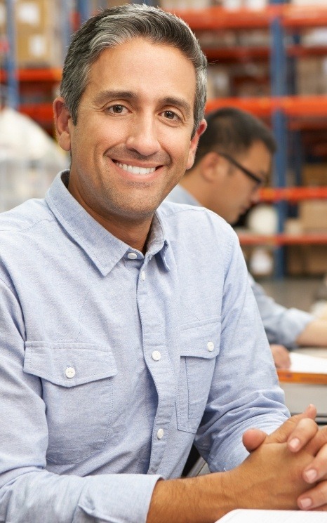 Man smiling in dental office building