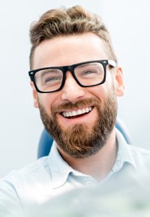 patient smiling while sitting in dental treatment 