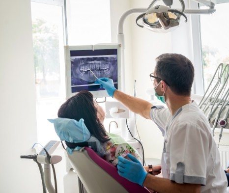 Dentist and dental patient looking at digital x rays
