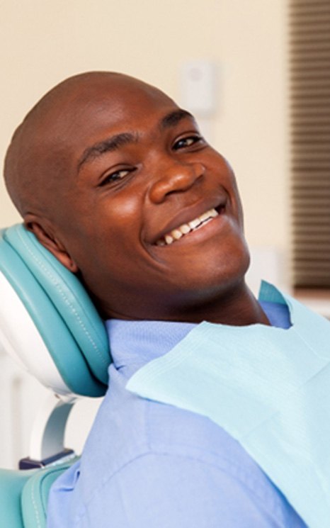 Smiling man sitting in dental chair