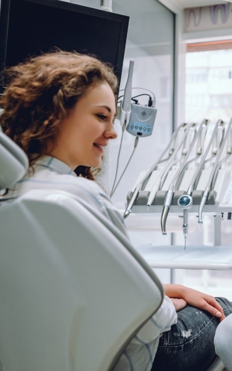 Woman in dentistry treatment room with advanced dental services and technology