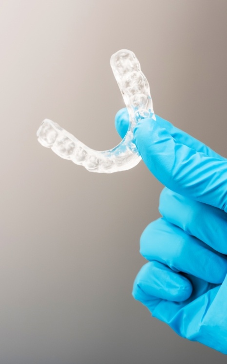 Hand holding an occlusal splint