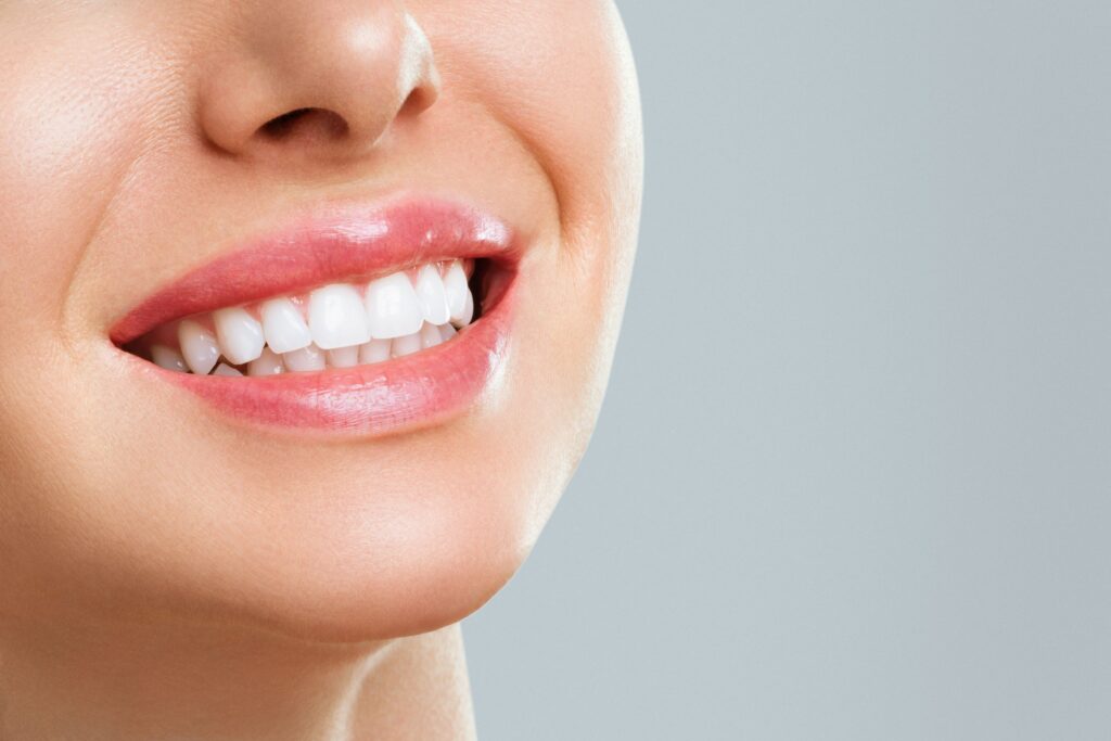 Nose-to-neck 3/4 profile closeup of woman's smile