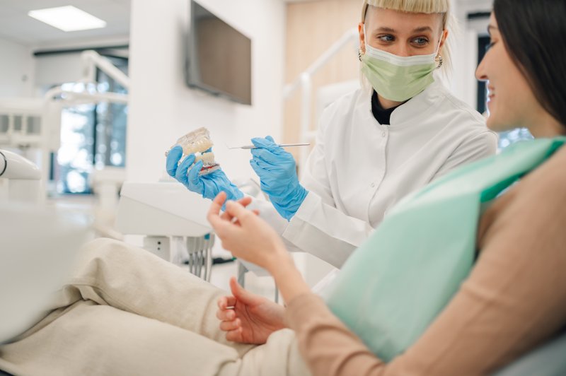 dentist talking to patient about dental implants
